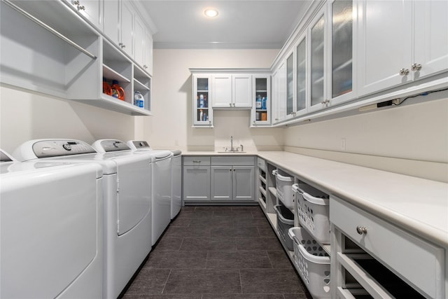 laundry area featuring sink, cabinets, and independent washer and dryer