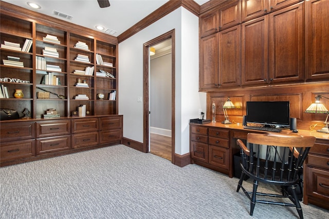 carpeted office space featuring crown molding and ceiling fan