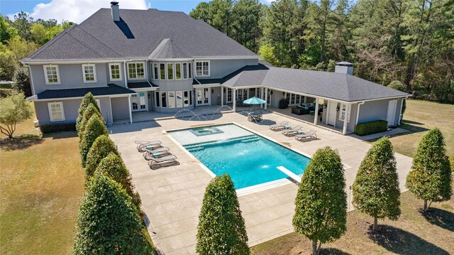 6090 Graemont Blvd, Tyler, TX 75703 - back of house featuring a chimney, a patio, an outdoor pool, and stucco siding