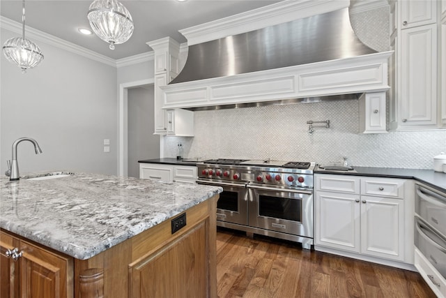 kitchen with white cabinetry, sink, double oven range, and ornamental molding