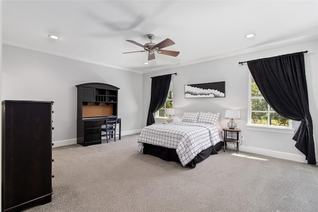 carpeted bedroom featuring ceiling fan and crown molding