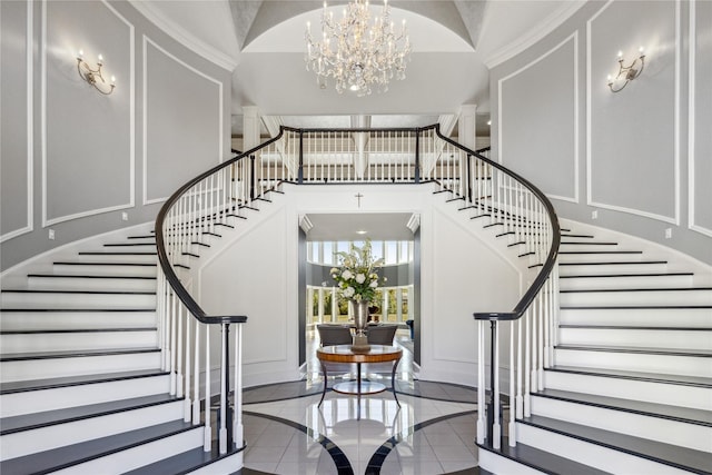 stairway with tile patterned flooring and a chandelier