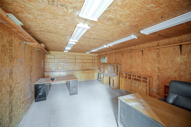 basement featuring wood walls