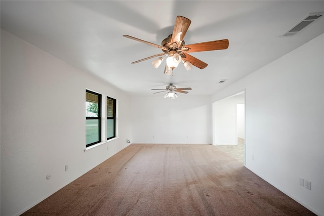 carpeted spare room with ceiling fan