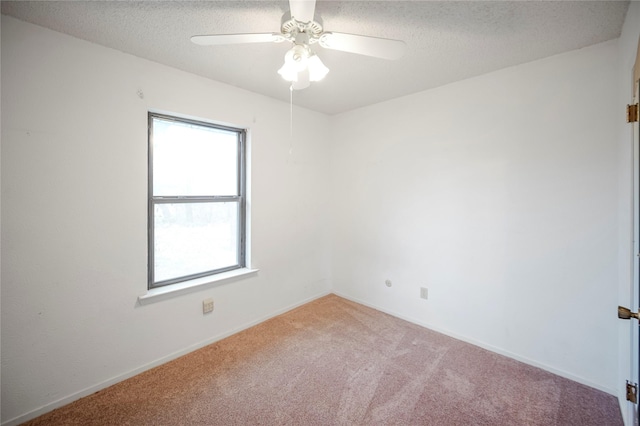 spare room with carpet flooring, ceiling fan, and a textured ceiling