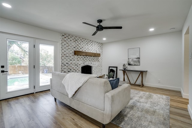 living room featuring light wood-type flooring and ceiling fan