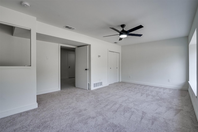 carpeted spare room featuring ceiling fan