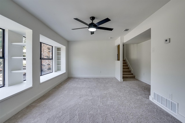 carpeted empty room featuring ceiling fan