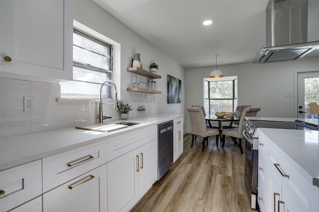 kitchen featuring backsplash, stainless steel appliances, sink, decorative light fixtures, and white cabinetry