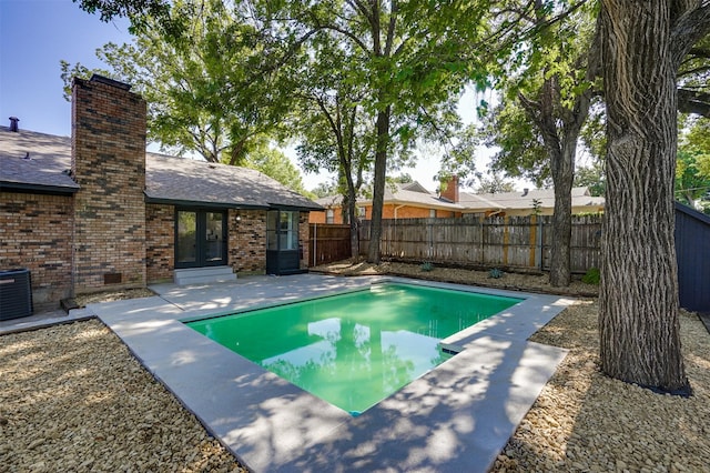 view of pool with a patio area and central AC