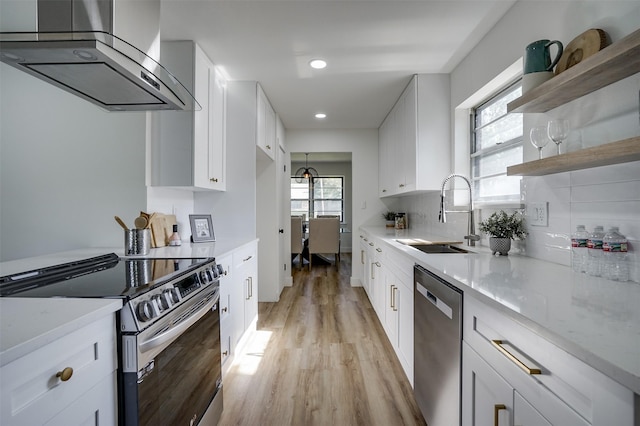 kitchen with white cabinets, stainless steel appliances, and exhaust hood