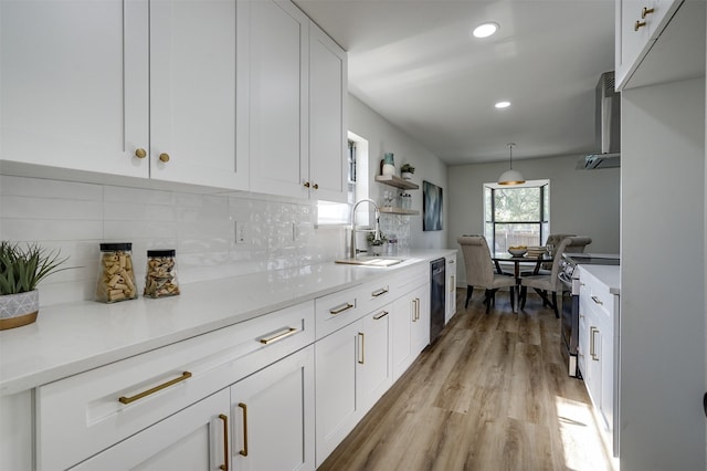 kitchen featuring dishwasher, white cabinets, sink, stainless steel electric range oven, and tasteful backsplash