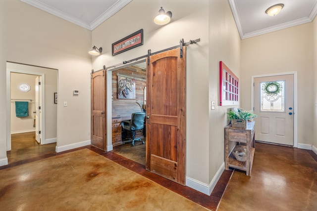 entrance foyer with a barn door and crown molding