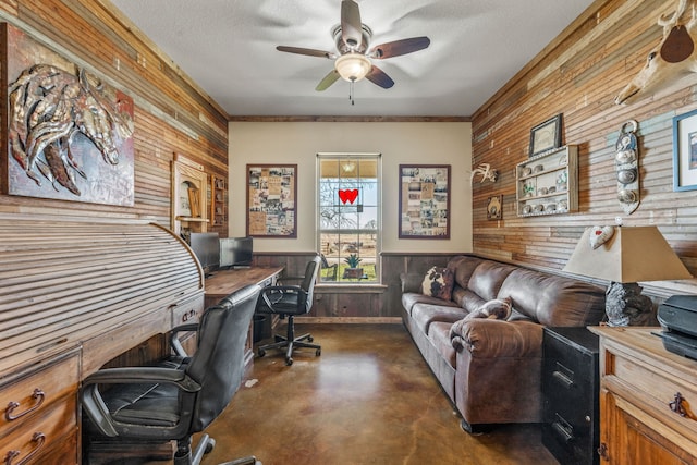 home office with ceiling fan, ornamental molding, a textured ceiling, and wooden walls