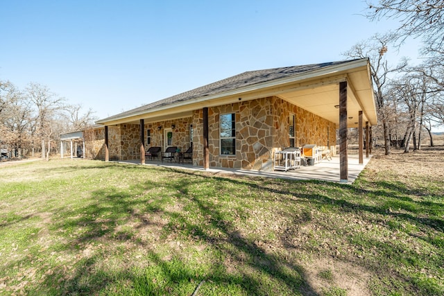 rear view of house featuring a yard and a patio area