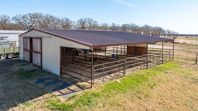 view of stable with a rural view