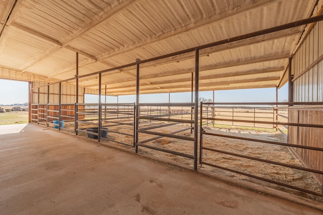 view of horse barn with a rural view