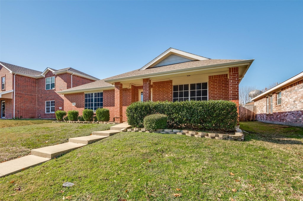 ranch-style home with a front lawn