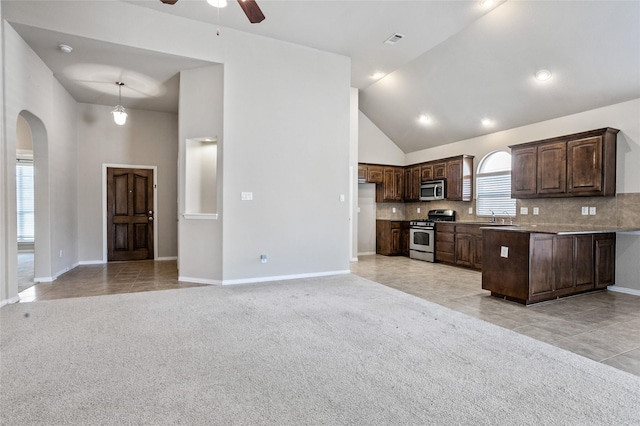 kitchen featuring light tile patterned floors, decorative backsplash, sink, dark brown cabinetry, and stainless steel appliances