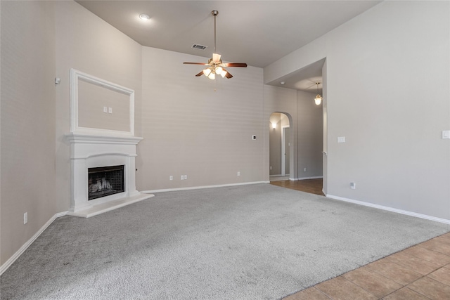 unfurnished living room featuring light colored carpet and ceiling fan