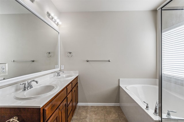 bathroom featuring vanity, a tub, and tile patterned flooring