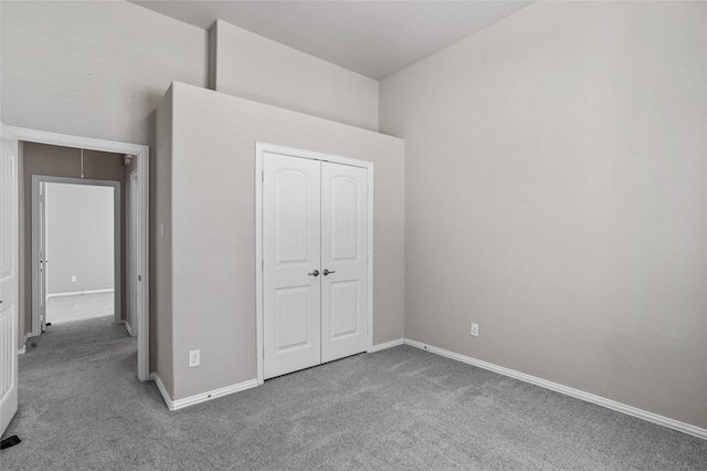 unfurnished bedroom with carpet floors and a closet