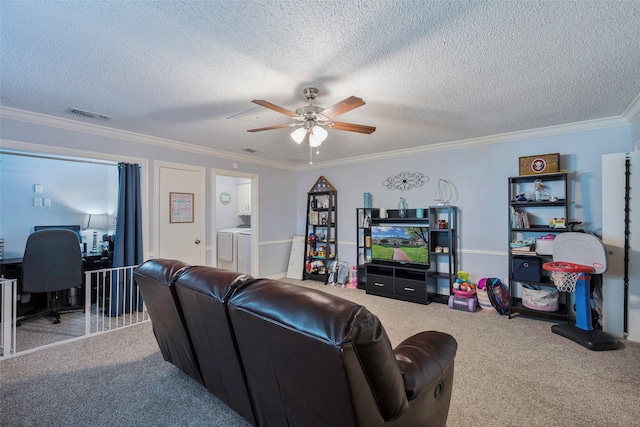 living room featuring crown molding, a textured ceiling, carpet floors, ceiling fan, and washing machine and dryer