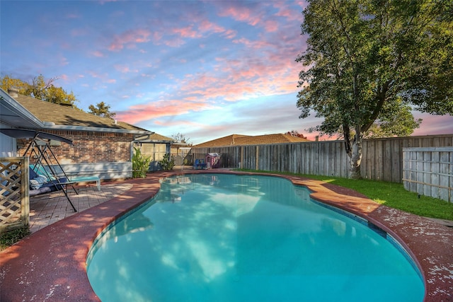 view of pool at dusk