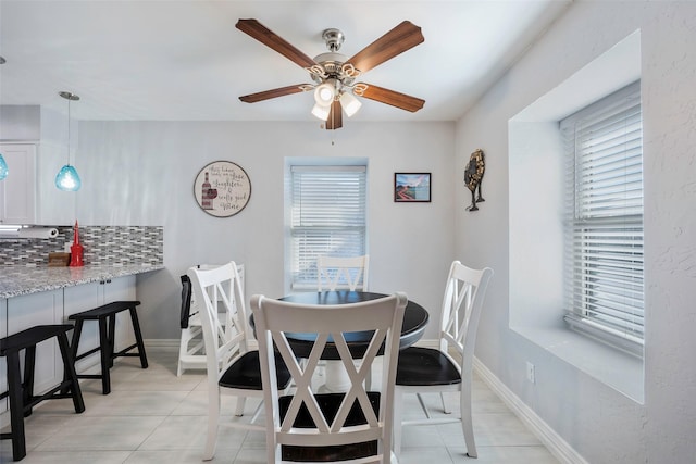 dining area with ceiling fan and light tile patterned floors