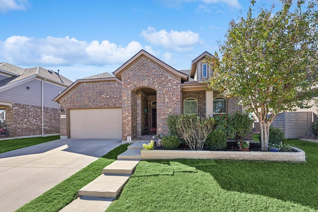 view of front facade with a garage and a front lawn