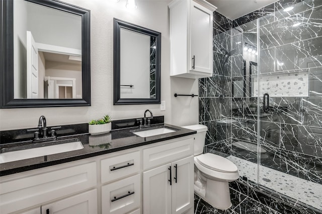 bathroom featuring vanity, toilet, and a shower with shower door