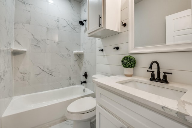 full bathroom with vanity, toilet, and tiled shower / bath