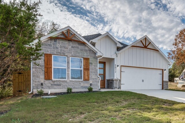 view of front of home with a front yard and a garage