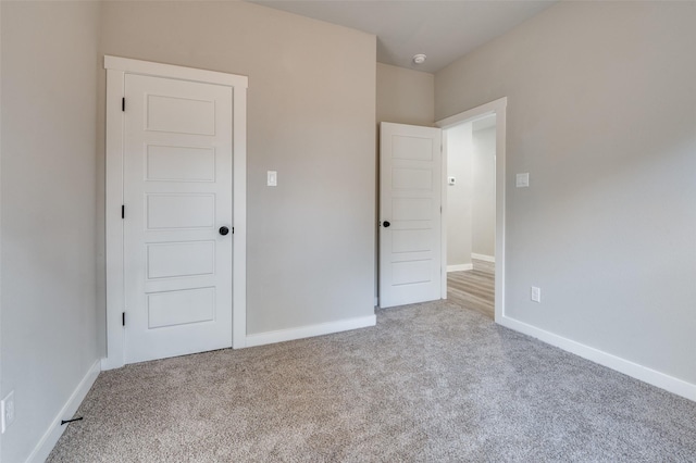 unfurnished bedroom featuring light colored carpet