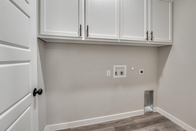 laundry room with electric dryer hookup, cabinets, washer hookup, and dark hardwood / wood-style floors