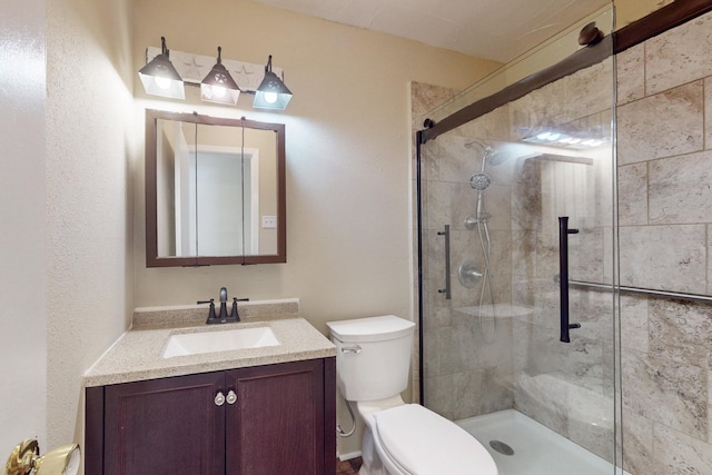 bathroom with vanity, an enclosed shower, and toilet