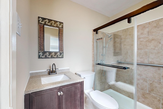 bathroom featuring an enclosed shower, vanity, and toilet