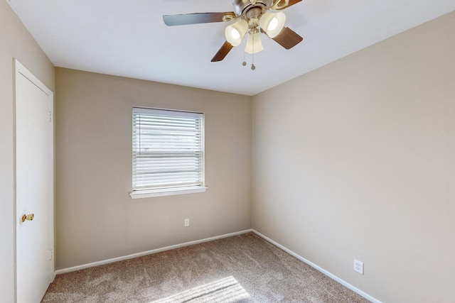 spare room featuring carpet floors and ceiling fan