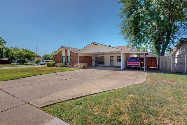 view of front of property with a front lawn and a carport