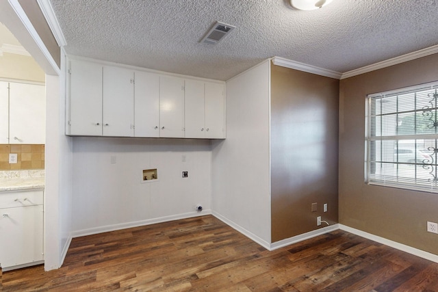 washroom featuring hookup for an electric dryer, washer hookup, dark hardwood / wood-style flooring, and ornamental molding