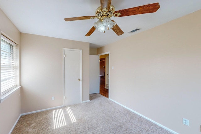 unfurnished bedroom featuring ceiling fan, a closet, and light carpet