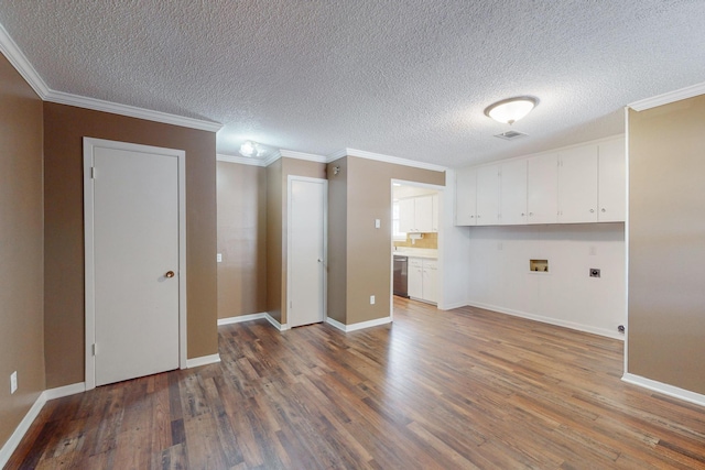 clothes washing area with cabinets, hookup for a washing machine, dark hardwood / wood-style flooring, crown molding, and electric dryer hookup