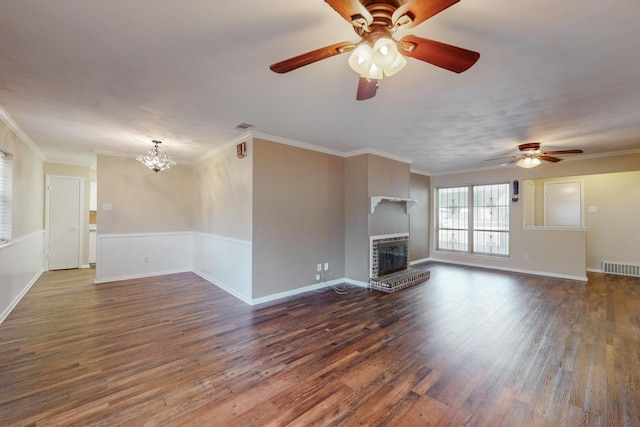 unfurnished living room with ornamental molding, dark wood-type flooring, and a brick fireplace