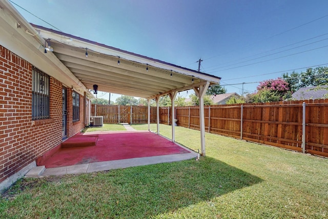 view of yard featuring a patio area and central air condition unit