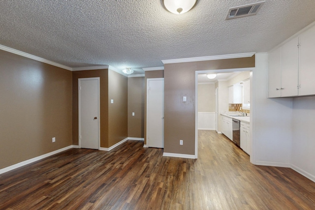 interior space featuring a textured ceiling, dark hardwood / wood-style flooring, ornamental molding, and sink