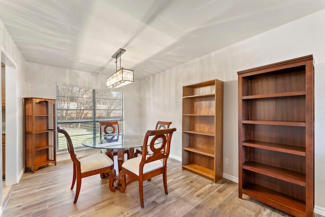 dining space featuring a notable chandelier and light hardwood / wood-style flooring