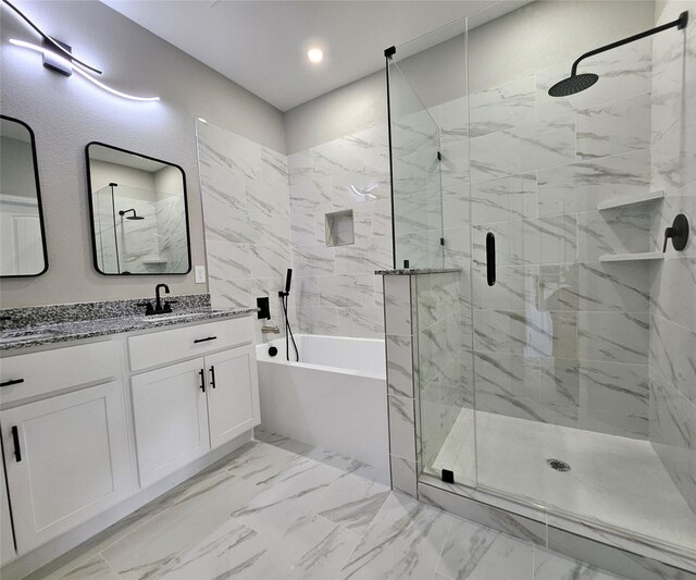 bathroom with vanity and shower with separate bathtub