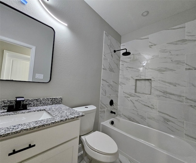 full bathroom with vanity, tiled shower / bath combo, and toilet