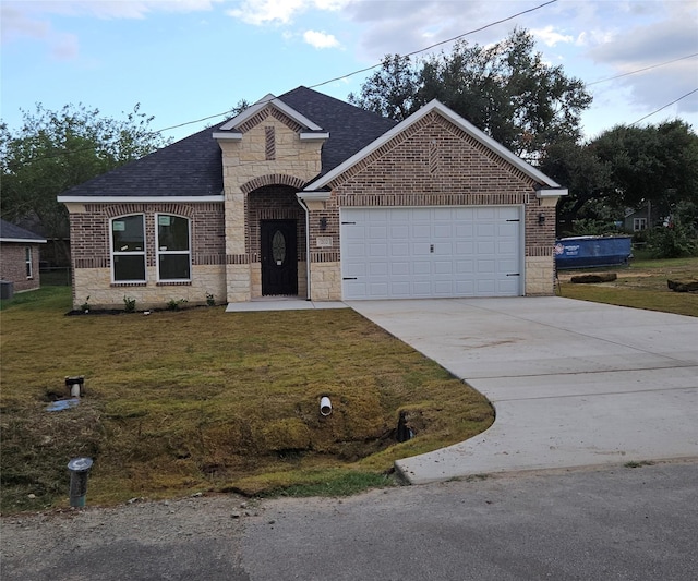 view of front of house with a front yard and a garage