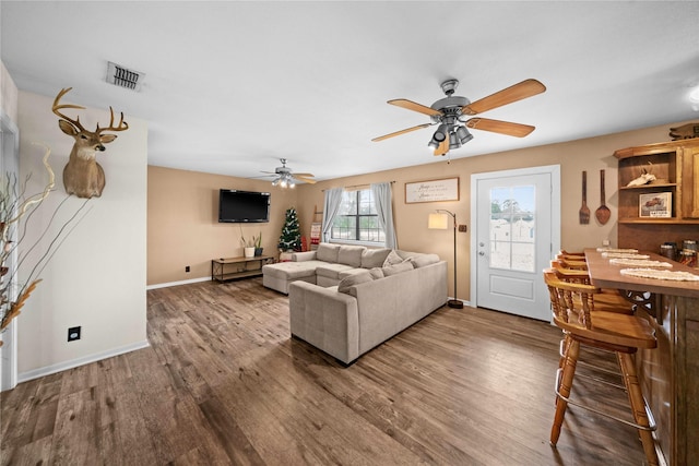 living room featuring ceiling fan and hardwood / wood-style floors